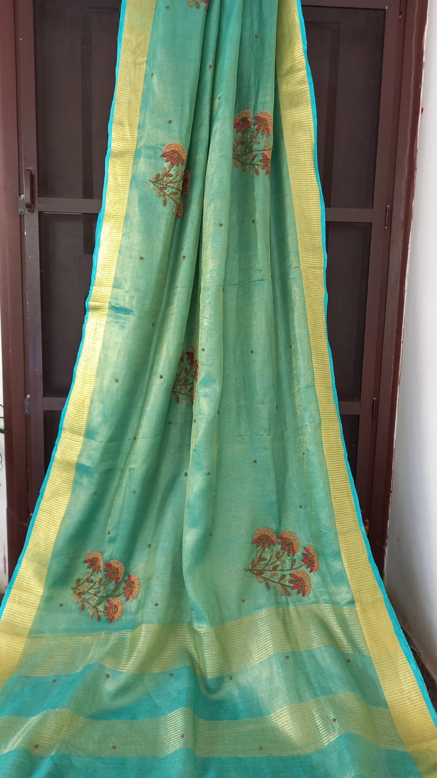 HANDWOVEN SKY BLUE TISSUE LINEN SAREE WITH HAND EMBROIDERY